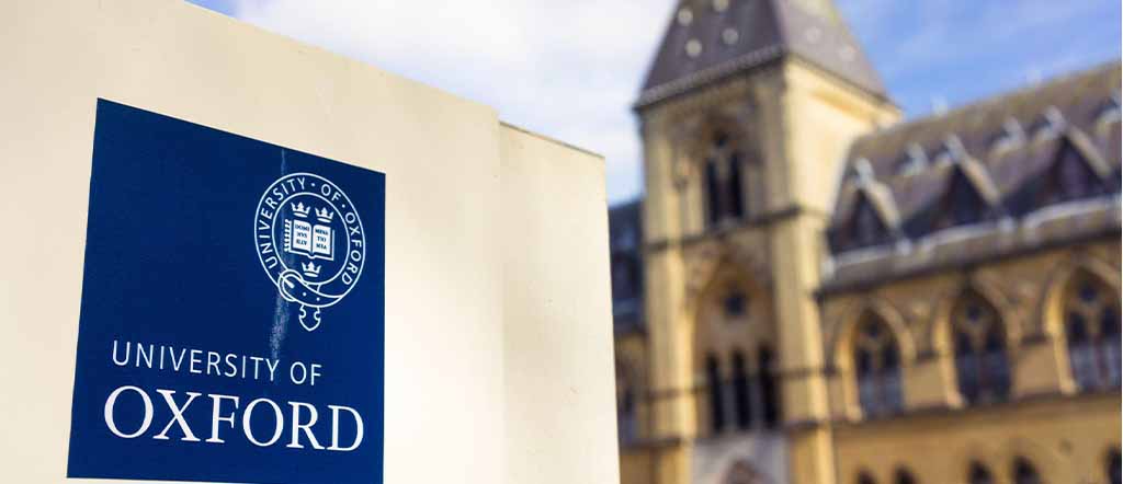 Name plate of oxford university is in focus where as oxford university building is in background and blurred 